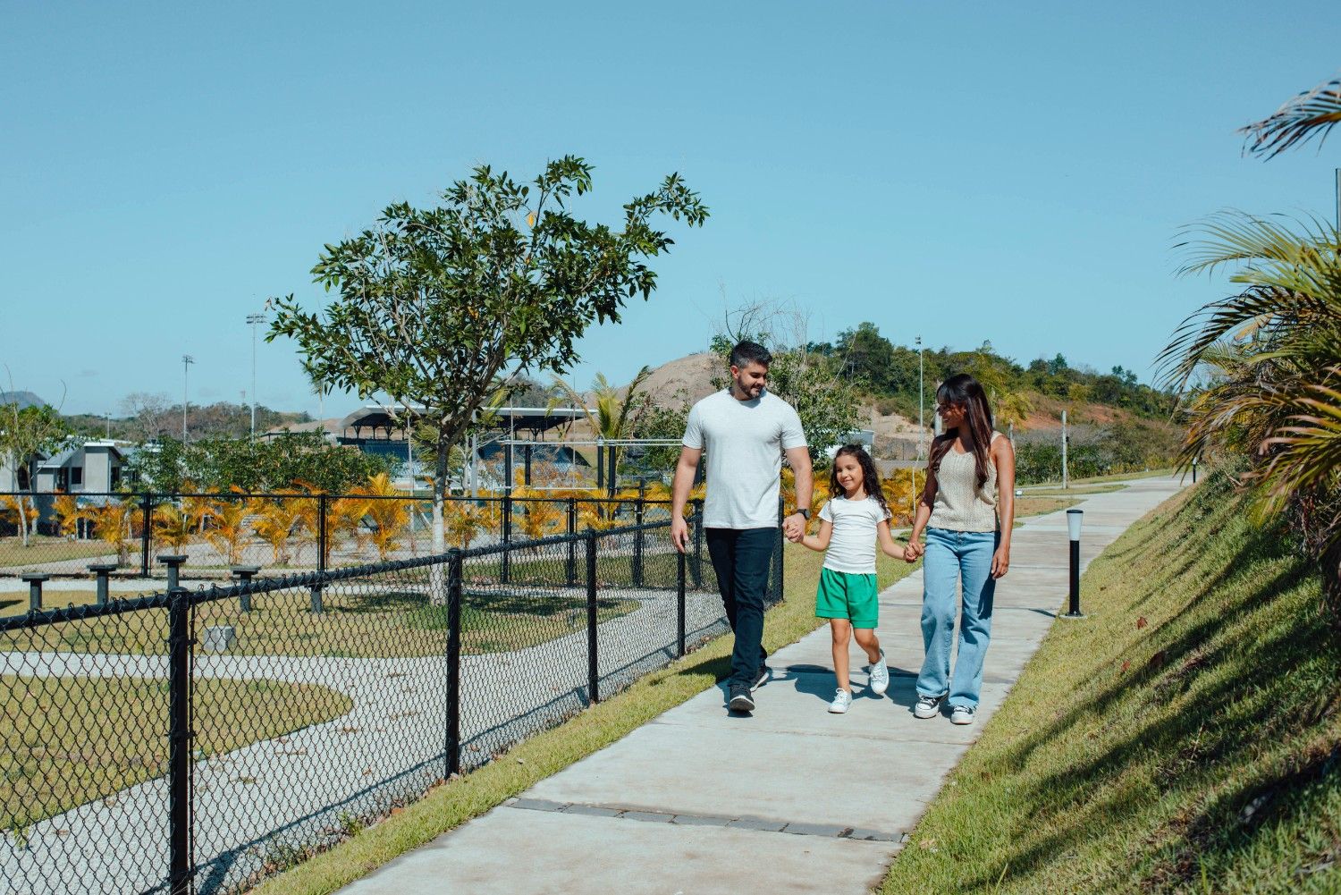 Familia de tres paseando por los exteriores del residencial Cavana en Paseo del Norte.